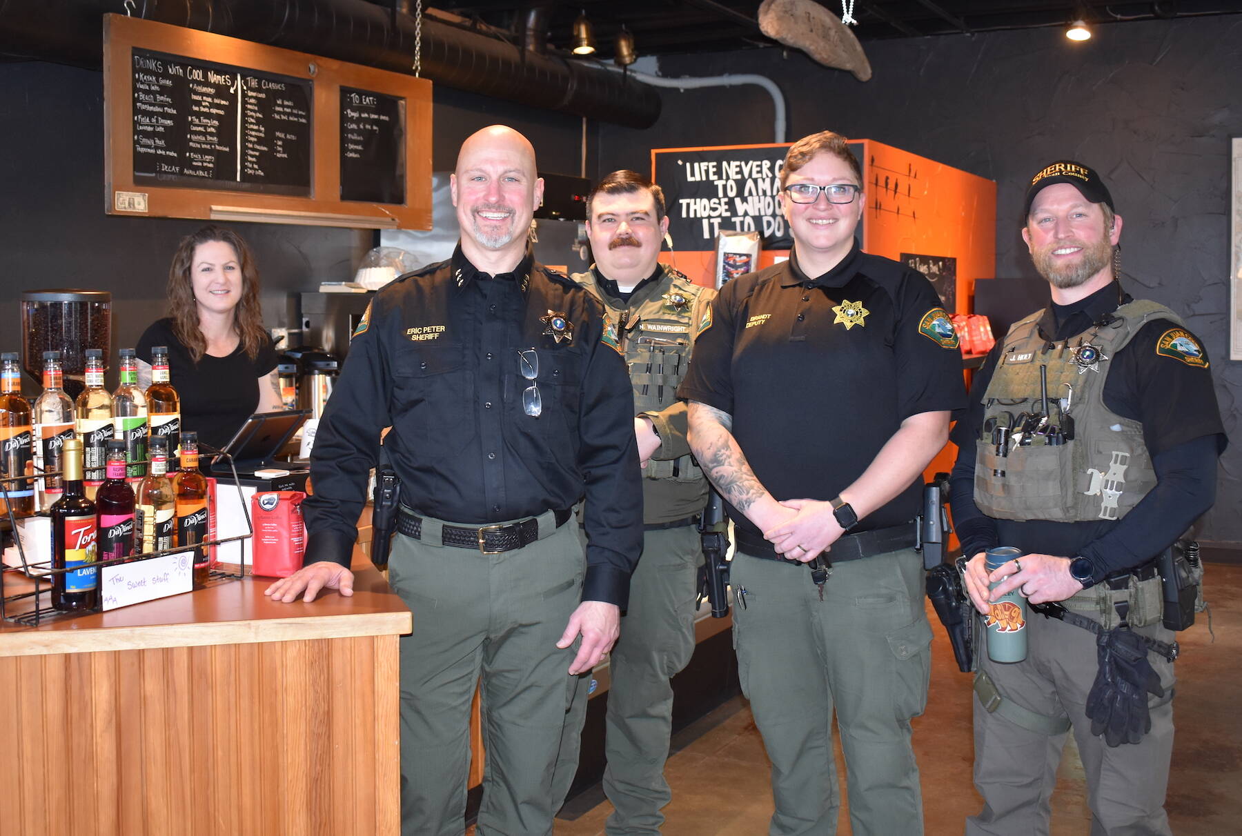 Kelley Balcomb-Bartok Staff photo
Sheriff Eric Peter is flanked by 13 Ravens Coffee owner Liberty Miller (left), and officers Nick Wainwright, Rion Brandt, and Jay Holt during the department’s first “Coffee With A Cop” event held January 28 in Friday Harbor.