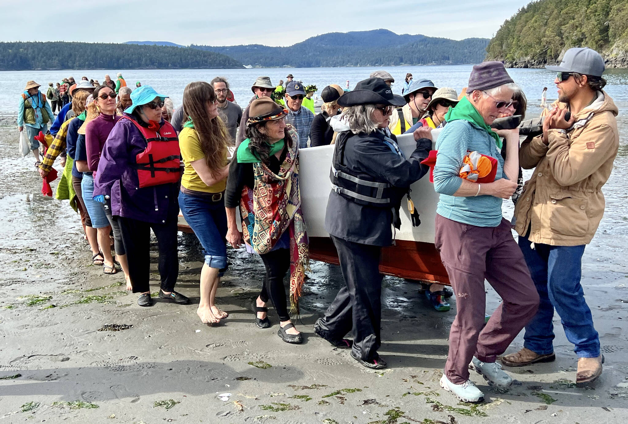 Contributed photo Lopez Friends of Canoe Landings
Volunteers help carry a canoe up the Odlin Park beach during the May 2022 canoe journey.