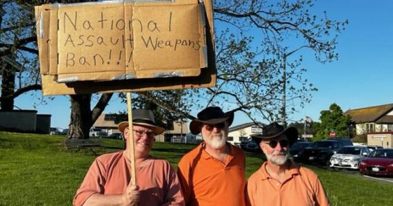 Heather Spaulding Staff photo 
From left to right: Ken Crawbuck and friends shine a spotlight on gun violence.