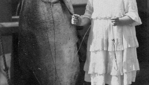 Contributed photo by the San Juan Island Historical Museum. 
Grace (Dolly) Washburn c. 1917. The King salmon weighed 108 pounds, Grace weighed 65 lbs, she was 11 years old. The fish was caught in one of the fish traps off South Beach, San Juan Island.