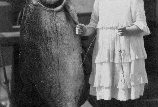 Contributed photo by the San Juan Island Historical Museum. 
Grace (Dolly) Washburn c. 1917. The King salmon weighed 108 pounds, Grace weighed 65 lbs, she was 11 years old. The fish was caught in one of the fish traps off South Beach, San Juan Island.
