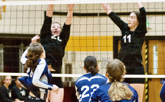 Contributed photo by Gene Hellman 
Betty Burt (20) and Ruby Ervin Mclean (11) go up to block against Fellowship Christian.