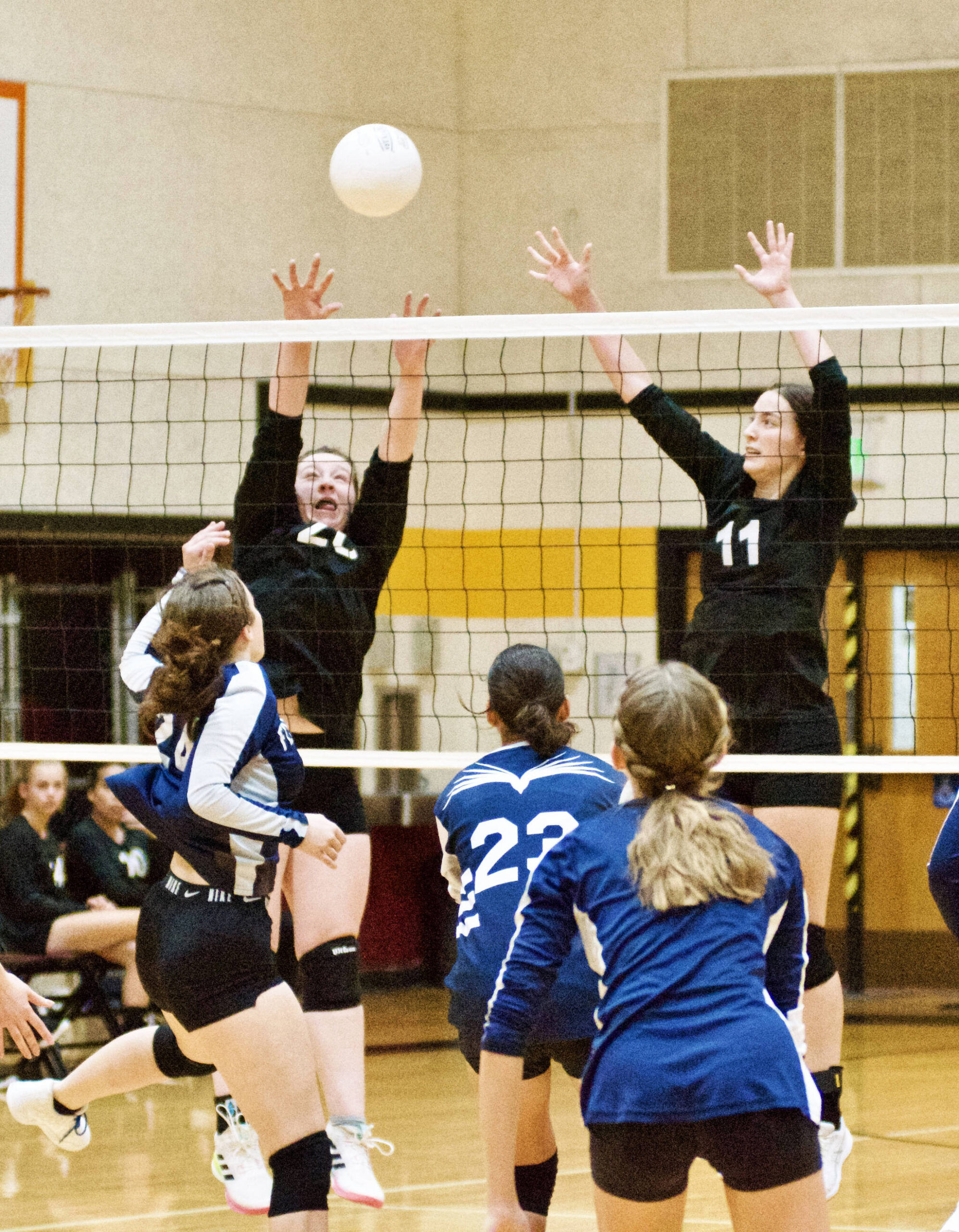 Contributed photo by Gene Hellman 
Betty Burt (20) and Ruby Ervin Mclean (11) go up to block against Fellowship Christian.