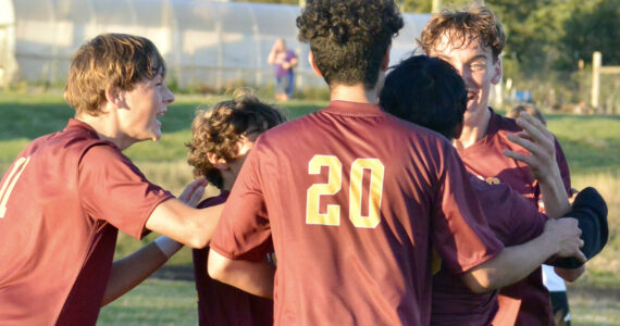 Contributed photo by Gene Helfman
Jubilant Lobos (left to right) Andris Meisner (#11), Juan Pelligrino, Henry Robles (20), and Ethan Patrick mob Jacob Velazquez-Velazco after his third and clinching goal of the match against Coupeville Oct 17.
