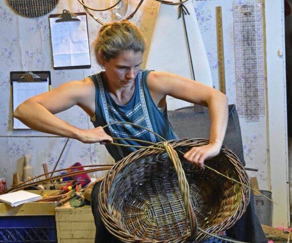 Maria Bullock weaving a basket.