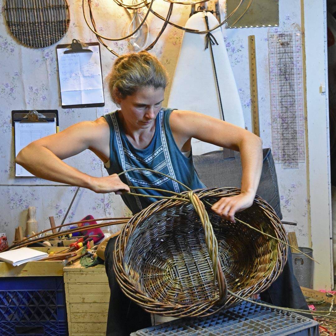 Maria Bullock weaving a basket.