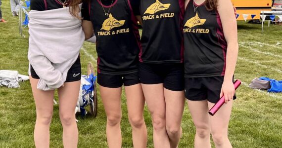 The Lobos girls’ 4x200 meter relay team of (left to right) Iris McClean, Glory Westervelt, Kylie Willemsen and Lily Nichols celebrate their one-second win over Providence Christian in their heat at La Conner, March 19. The Lobos were third overall in a seven-team field, with a personal record time of 1:59.18.