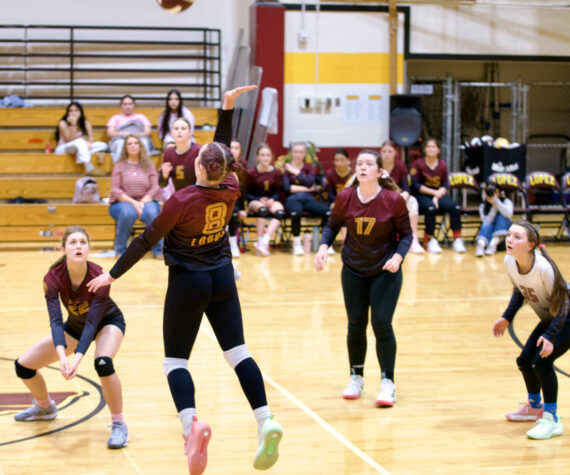 Gene Helfman photo.
Lyric Reed (8) leaps to spike the ball against Cedar Park as (left to right) Kylie Willemsen (22), Dani Arnott (5), Betty Burt (17), and Avila Sausman (35) watch.