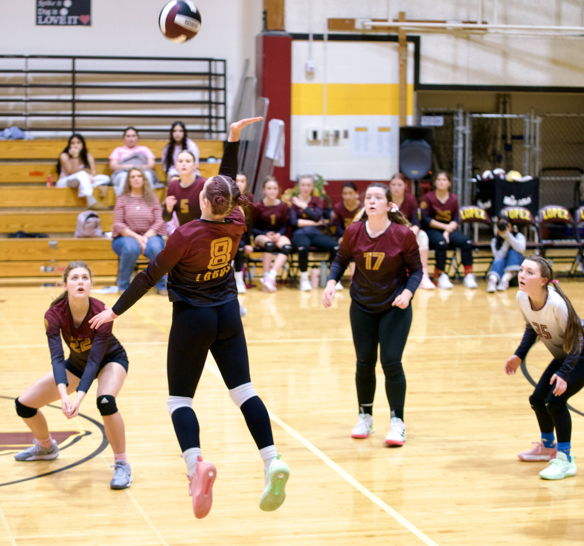 Gene Helfman photo.
Lyric Reed (8) leaps to spike the ball against Cedar Park as (left to right) Kylie Willemsen (22), Dani Arnott (5), Betty Burt (17), and Avila Sausman (35) watch.
