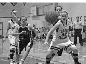  Eryn Dye (#22) blocks Lummi players as the ball goes out of bounds. Lopez had the game tied with two minutes to play but lost 33-30. 
