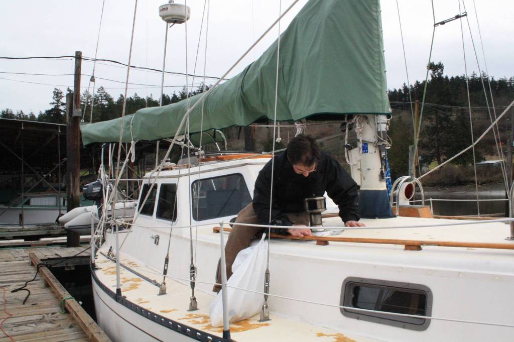 Staff photo/Hayley Day                                Nate Hertel repairs a boat deck at Albert Jensen and Sons Boat Yard and Marina on San Juan Island.