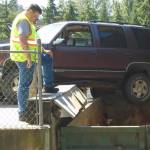 SUV dangles dangerously at the Lopez Dump