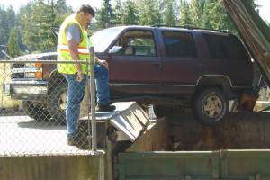 SUV dangles dangerously at the Lopez Dump