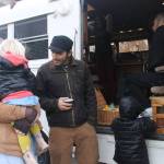Heather Spaulding/staff photo                                Guisepi aka Joe, Spadafora, sips tea while talking with an island mom and her children.