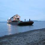 Contributed photo/OPAL                                An OPAL house is barged to Orcas Island.