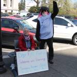 Contributed photo                                Lanni Johnson sitting in front of the capitol building steps where she has been on a hunger strike for the last 9 days to save the Southern Resident Orcas. Johnson is joined by supporter, Phil Myers, who can be seen in an orca onesie.