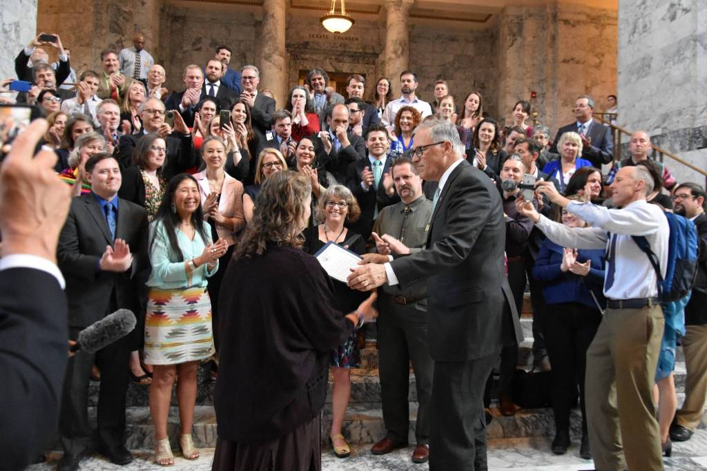 Gov. Jay Inslee reads an orca proclamation that declares June 2019 as Orca Action Month. He read the proclamation immediately after he signed five bills that will protect, aid, grow orca and salmon population in Salish Sea. (Office of the Governor photo)