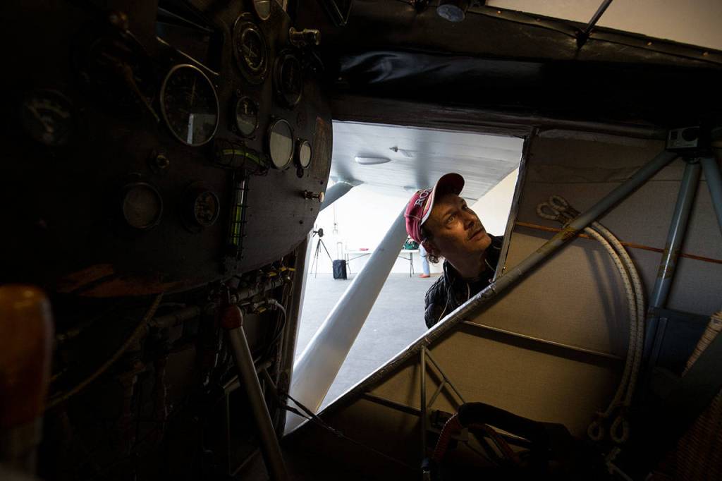 Antony Giacomini looks around the cockpit of John Normans replica of the Spirit of St. Louis on July 28. Giacomini is also building a replica but remarked that Normans was an exact replica, compared to his plane. (Andy Bronson / The Herald)