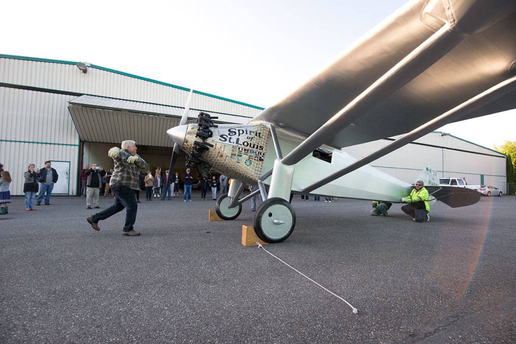 John Norman cranks the propeller of his Spirit of St. Louis replica July 28. (Andy Bronson / The Herald)