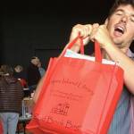 Contributed photo                                Charlie McGready hoists a full Red Bag in support of the Lopez Library Book Sale.