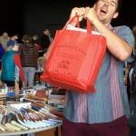 Contributed photo                                Charlie McGready hoists a full Red Bag in support of the Lopez Library Book Sale.
