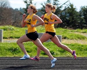 Contributed photo
Clara Ewert (foreground) and Erin Wilbur compete stride-for-stride in the 880-yard run  the toughest race in track  during a Lopez meet in April 2011.