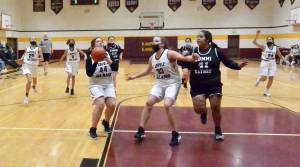 Betty Burt (44) prepares to shoot while Danielle Arnott (33) screens for her and Naima Garcia (20), Michelle Gil (5), and Melissa Valencia (24) move in on a fast break versus Lummi Nation.