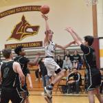 Contributed photo
Ethan Patrick scores despite three Shoreline Christian defenders in the Lobos close loss Dec. 6th.