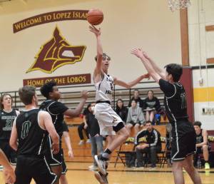 Contributed photo
Ethan Patrick scores despite three Shoreline Christian defenders in the Lobos close loss Dec. 6th.