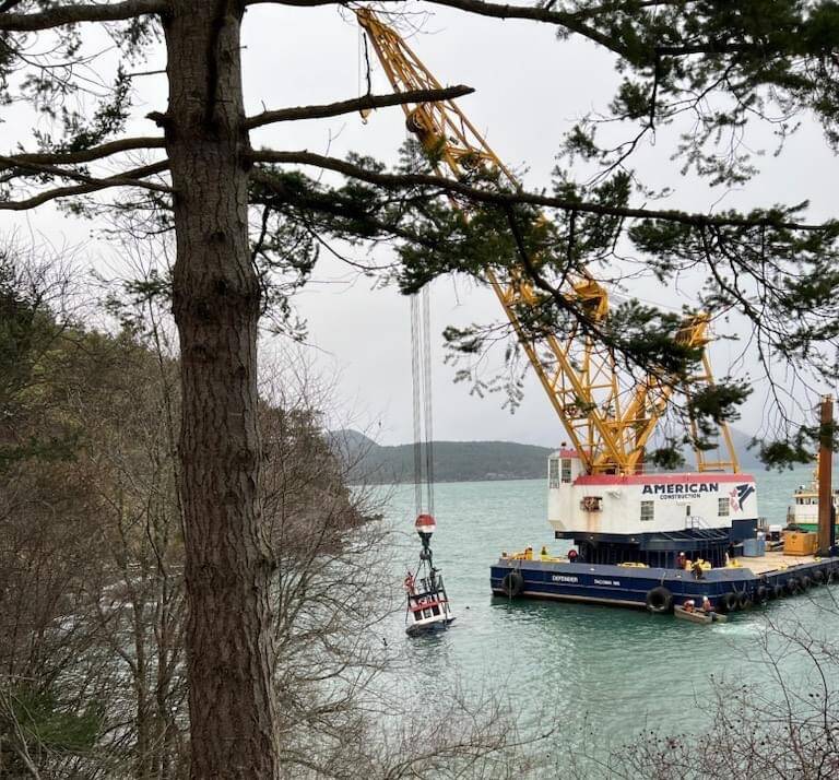 Contributed photo.
The partially submerged Tugboat Tulalip is suspended near the Lopez ferry terminal in preparation for removal.