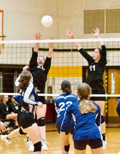 Contributed photo by Gene Hellman 
Betty Burt (20) and Ruby Ervin Mclean (11) go up to block against Fellowship Christian.