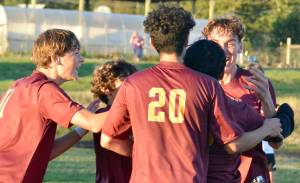 Contributed photo by Gene Helfman
Jubilant Lobos (left to right) Andris Meisner (#11), Juan Pelligrino, Henry Robles (20), and Ethan Patrick mob Jacob Velazquez-Velazco after his third and clinching goal of the match against Coupeville Oct 17.