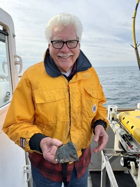 Adam Summers photo
Dr. H. Gary Greene holds a sample of vesicular basalt at the site of the Devils Mountain Volcano