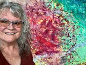 Contributed photo
Amanda Azous in front of one of her paintings.