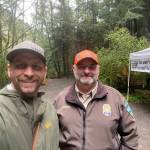 WDFW district biologist Kurt Licence and BLM staff at the kiosk near Watmough Bay on southern Lopez Island.