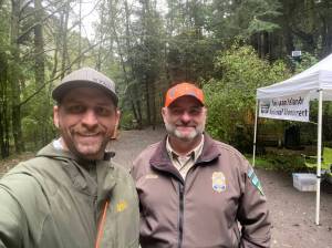 WDFW district biologist Kurt Licence and BLM staff at the kiosk near Watmough Bay on southern Lopez Island.