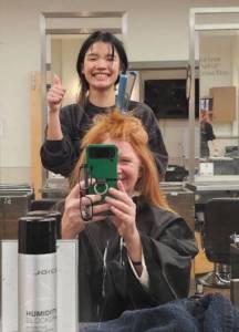Kai at work, with fellow beauty college student Janise Rands.