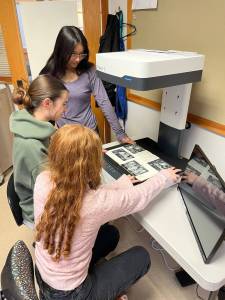 Lopez School students digitizing a yearbook.