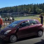 At right: Screenshot from a video provided by Leo Baker as Guilherme Silva was taken onto a boat for transfer. An ICE agent can be seen snapping photos of the marina view behind him.