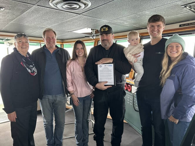 Capt. John McMillian (center) with Sheridan Ferguson and her father (left center), Brent Campbell and family (right), and Margaret Pommert with U.S. Sailing Foundation (far left).