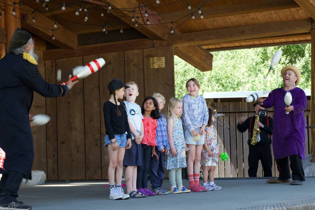 Paul Magid, far left, and Fable the Clown, far right, at the 2026 Orcas Island Solstice Parade.